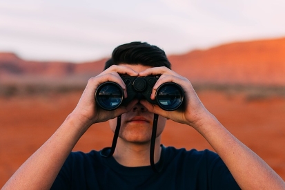 Catholic Stock Choices Represented as Man Looking through Binoculars